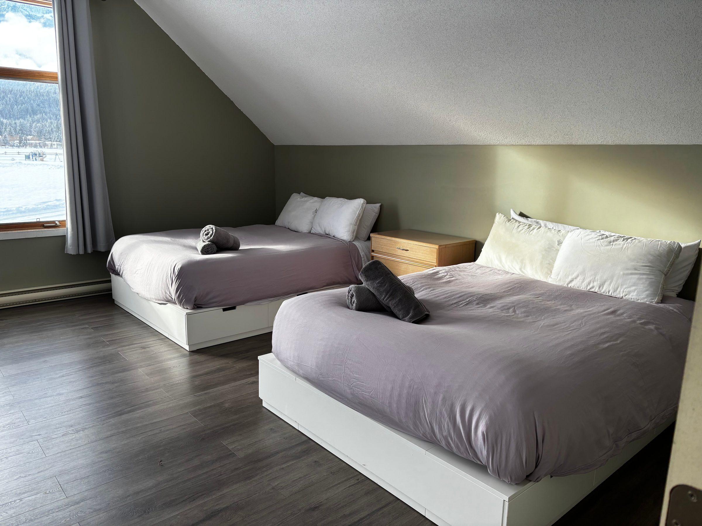 Queen beds inside the Mountain Magic Apartment